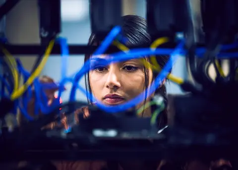 closeup of woman working on networking cables