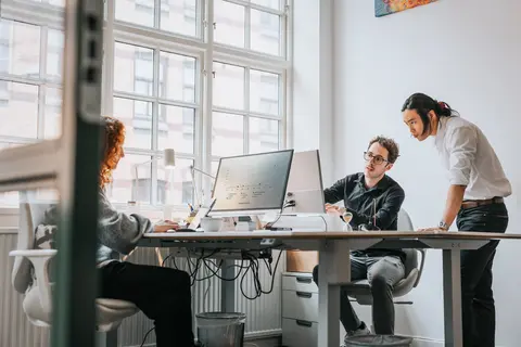 three people in office collaborating