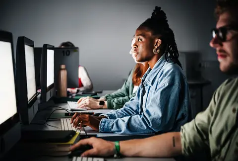 Students concentrate while working on a computer assignment